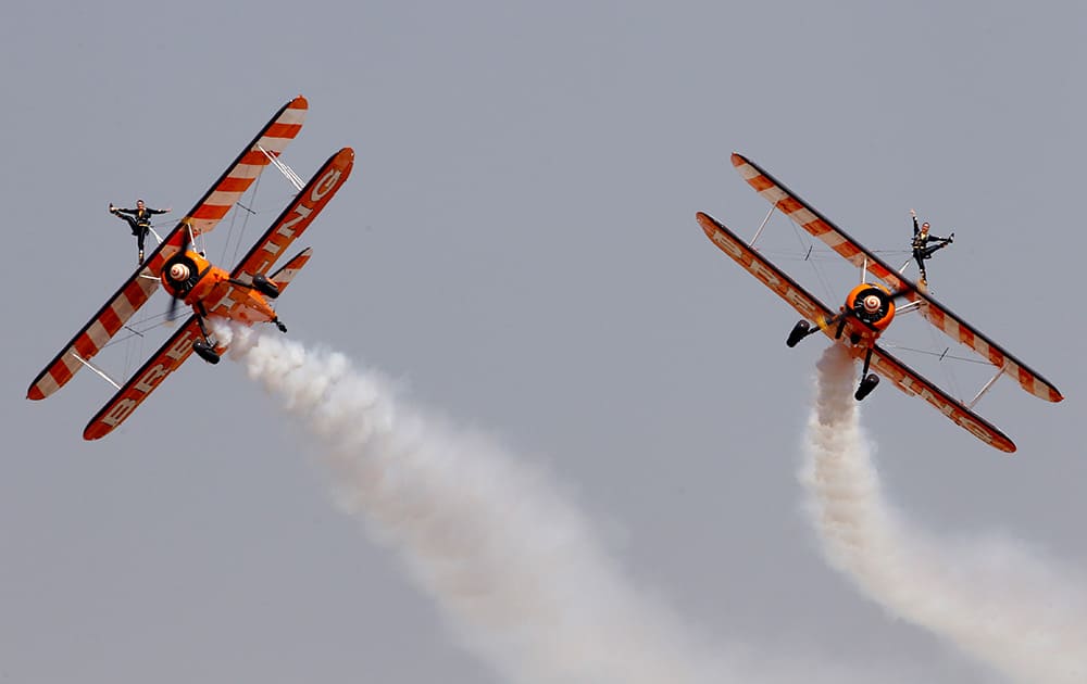 Members of the British aerobatics team Breitling Wingwalkers perform on the third day of Aero India 2015 at Yelahanka air base in Bangalore.