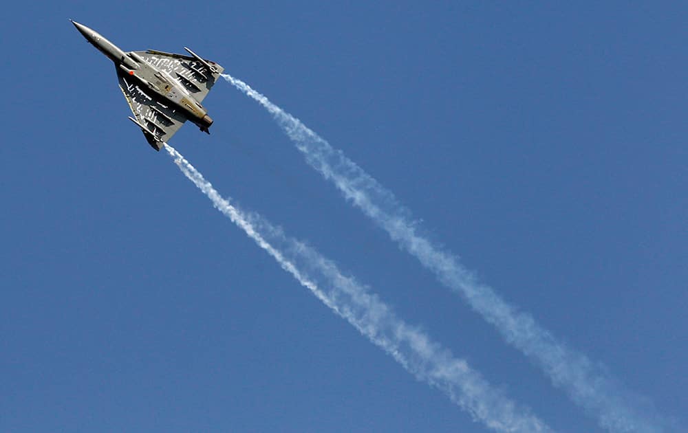 Tejas, an Indian Air Force light combat aircraft flies on the third day of Aero India 2015 at Yelahanka air base in Bangalore.