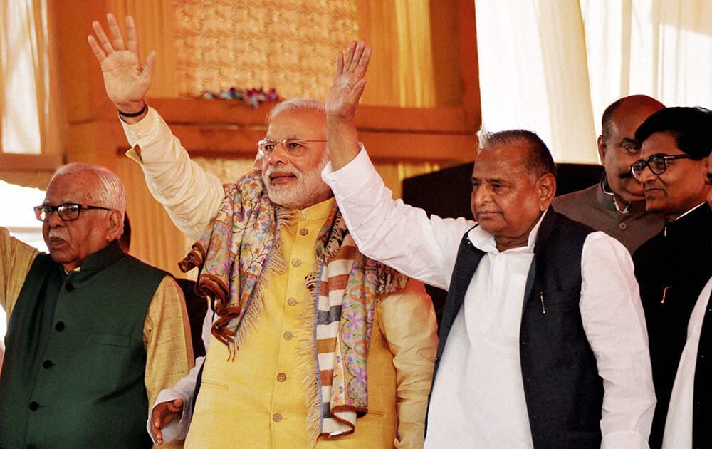 Prime Minister Narendra Modi waves along with Samajwadi Party chief Mulayam Singh Yadav at the Tilakceremony of Tej Pratap Singh Yadav, grand-nephew of Yadav and Raj Laxmi, daughter of Lalu Prasad, in Saifai.