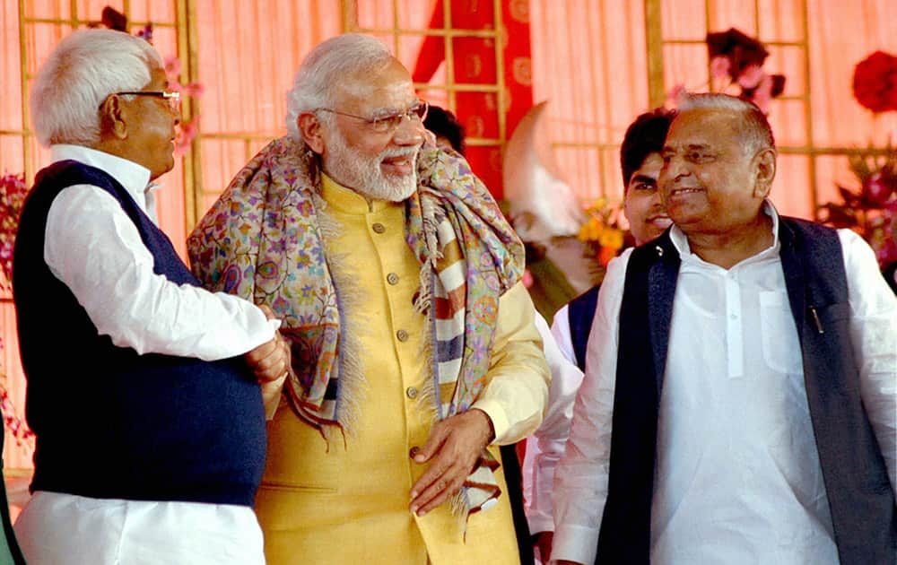 Prime Minister Narendra Modi shakes hands with RJD chief Lalu Prasad Yadav at the Tilakceremony of Tej Pratap Singh Yadav, grand-nephew of Mulayam Singh Yadav (R) and Raj Laxmi, daughter of Lalu Prasad, in Saifai.