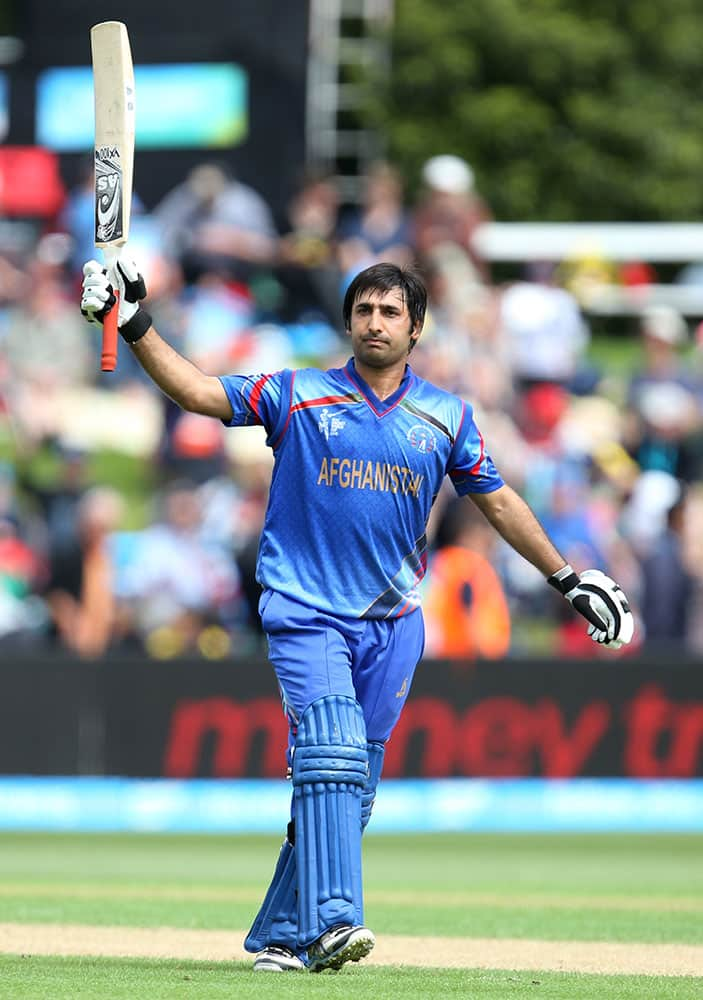 Afghanistan’s Asghar Stanikzai waves his bat to the crowd after reaching 50 runs during their Cricket World Cup match against Sri Lanka in Dunedin, New Zealand.