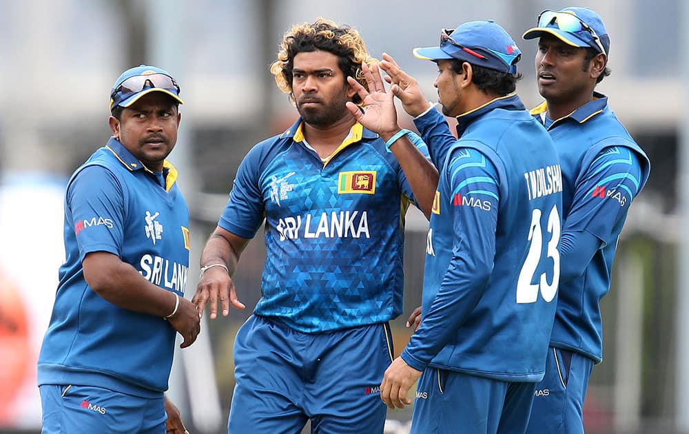 Sri Lanka's Lasith Malinga, second left, is congratulated by teammates after taking the final wicket to dismiss Afghanistan’s during their Cricket World Cup match in Dunedin, New Zealand.