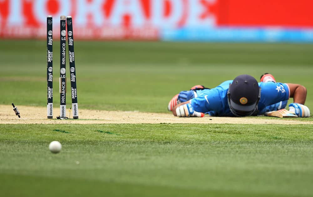 India's Rohit Sharma lies on the ground after he was run out during their Cricket World Cup pool B match against South Africa in Melbourne, Australia.