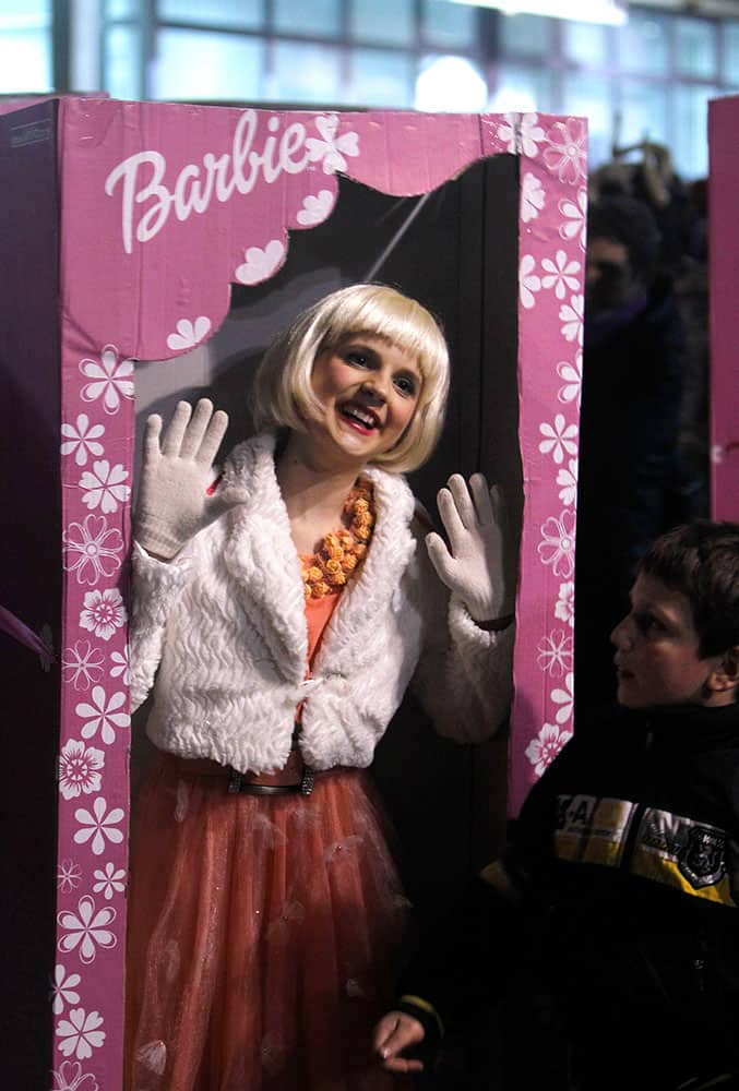 A costumed reveler in a Barbie box performs during a carnival in the southeastern Macedonia's town of Strumica.