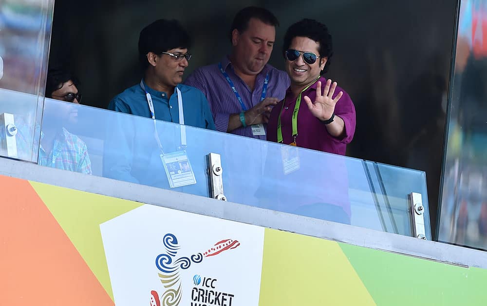 Former Indian cricketer Sachin Tendulkar waves to the crowd as he watches the Cricket World Cup pool B match between India and South Africa at the Melbourne Cricket Ground in Melbourne, Australia.