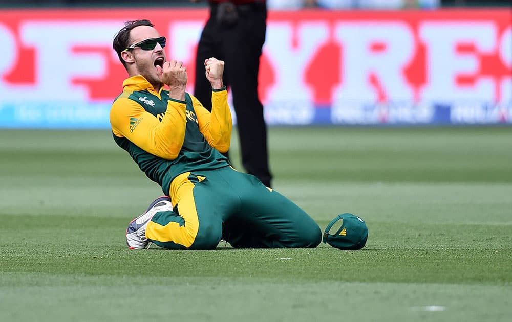 South Africa's Francois Du Plessis celebrates after taking a catch to dismiss India's Virat Kohli during their Cricket World Cup pool B match in Melbourne, Australia.