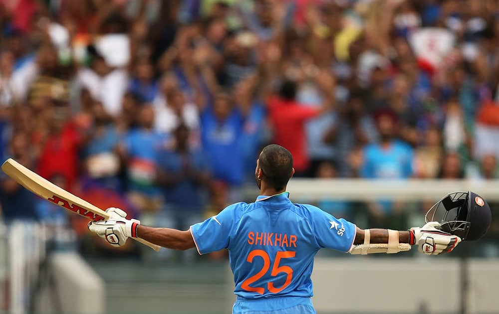 India's Shikhar Dhawan celebrates his hundred during their Cricket World Cup pool B match against South Africa in Melbourne, Australia.