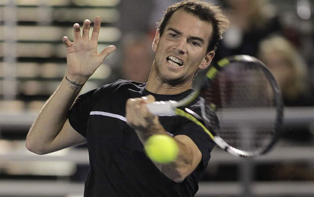 Adrian Mannarino of France, returns the ball to Ivo Karlovic, of Croatia, during a semi-final tennis match at the Delray Beach Open.