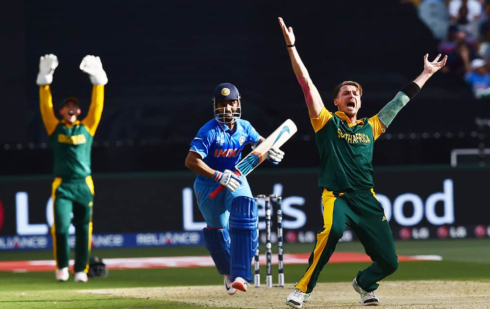 South Africa's Dale Steyn, right, appeals successfully to dismiss Indian batsman Ajinkya Rahane, centre, during their Cricket World Cup pool B match in Melbourne, Australia.