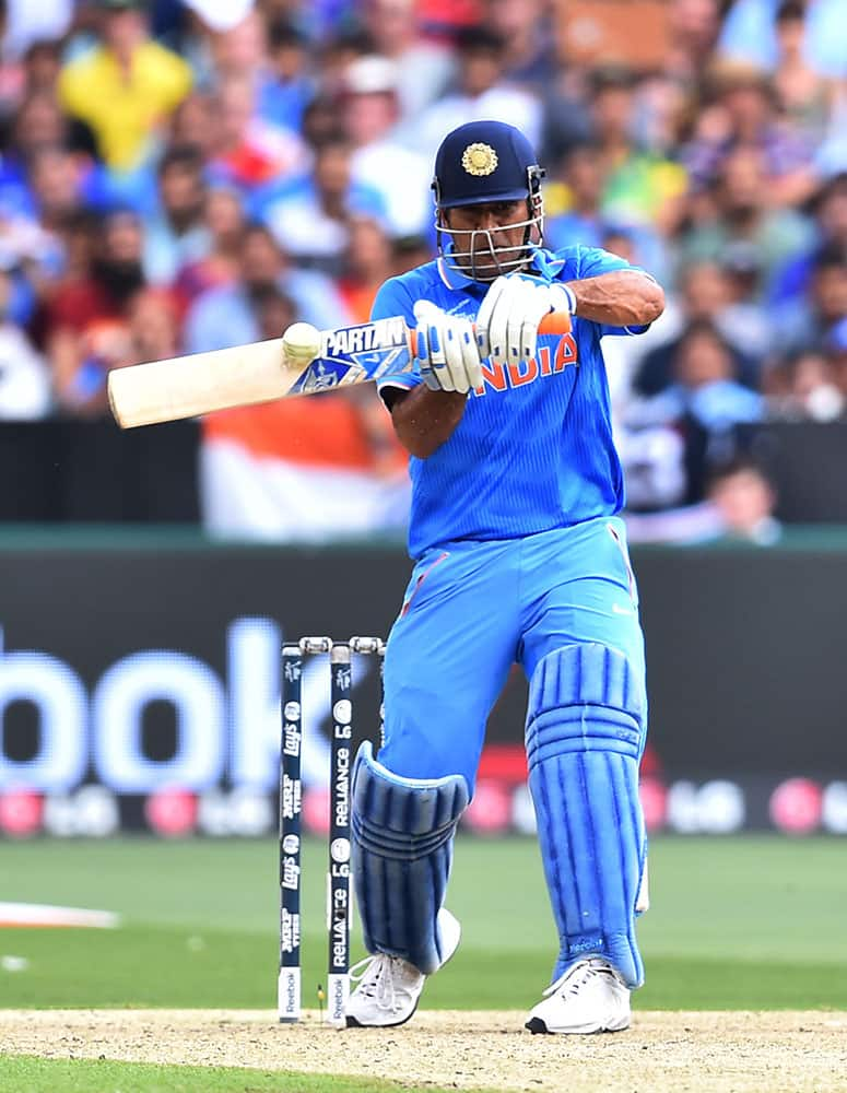 India's M S Dhoni hits the ball during their Cricket World Cup pool B match against South Africa in Melbourne, Australia.