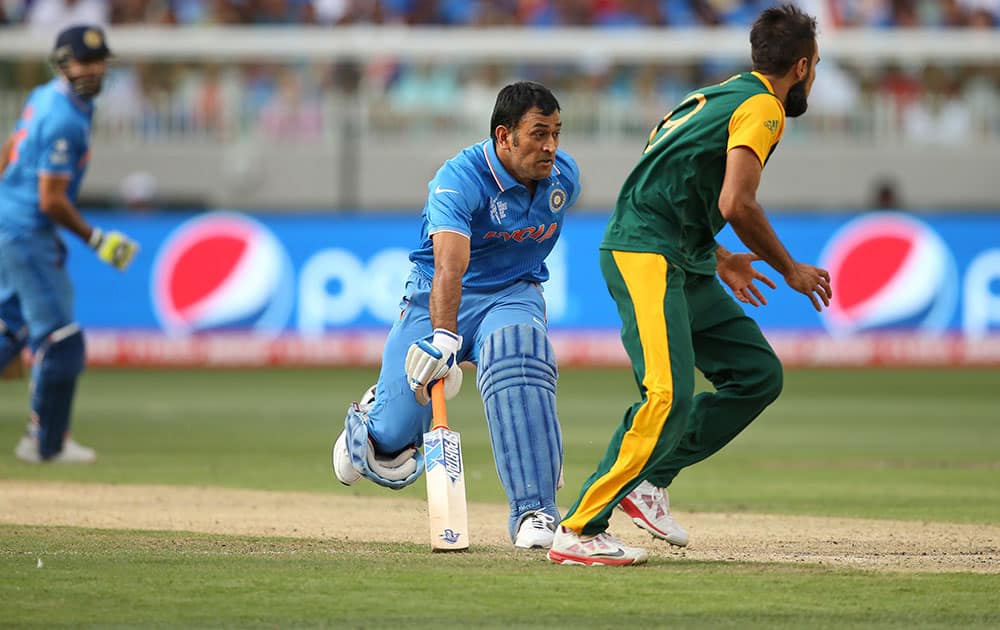 India's Mahendra Singh Dhoni, runs between wickets during their Cricket World Cup pool B match against South Africa in Melbourne, Australia.