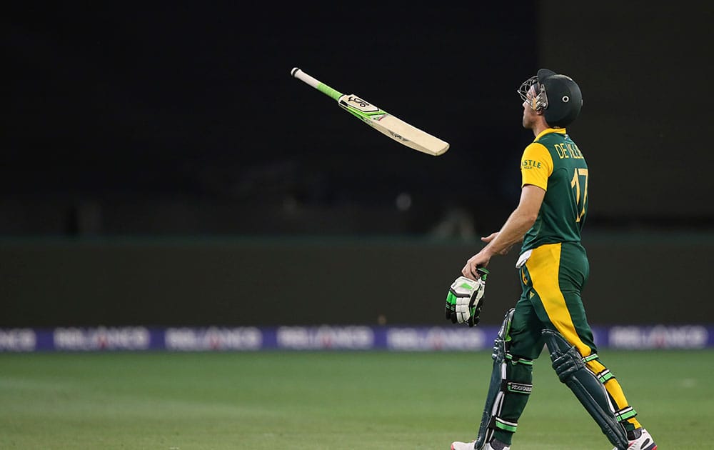 South Africa's A.B. de Villiers tosses his bat as he walks back after his dismissal during their Cricket World Cup pool B match against India in Melbourne, Australia.