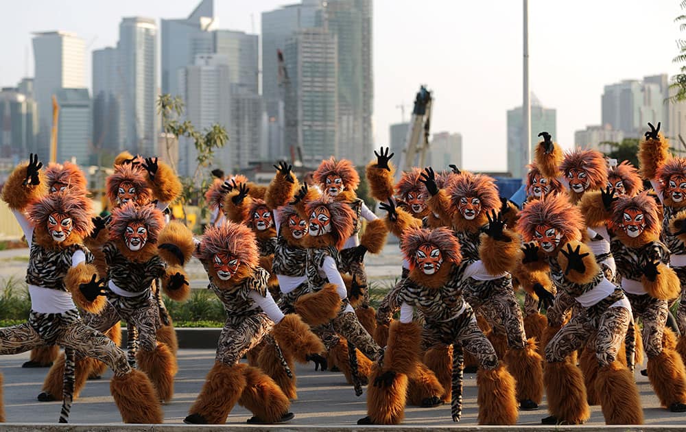 Filipino residents wearing costumes pose as they perform during the start of the annual 