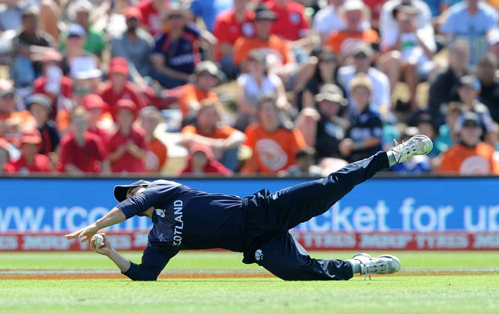 Scotland's Preston Mommsen takes a catch to dismiss England’s captain Eoin Morgan during their Cricket World Cup match in Christchurch, New Zealand.