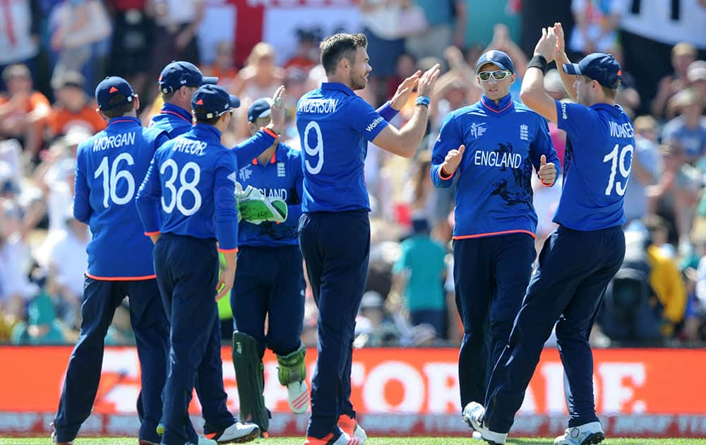 England's James Anderson, centre, is congratulated by teammates after dismissing Scotland batsman Calum MacLeod during their Cricket World Cup match in Christchurch, New Zealand.