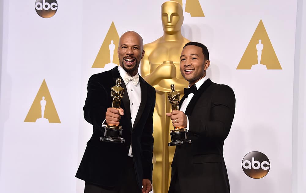 Common, left, and John Legend pose in the press room with the award for best original song in a feature film for “Glory” from “Selma” at the Oscars.