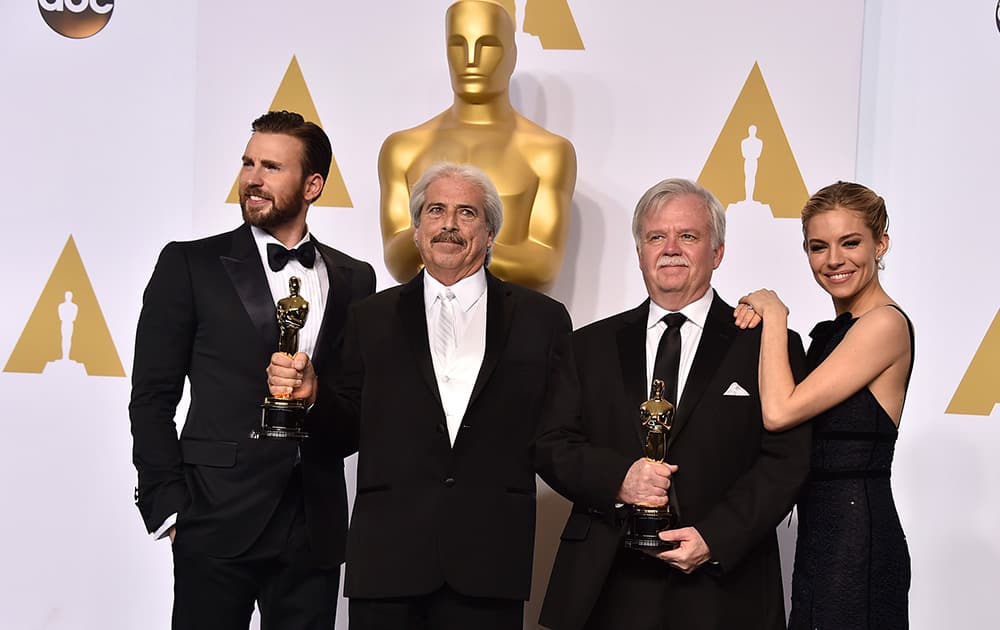 Chris Evans, and from left, Alan Robert Murray, Bub Asman and Sienna Miller pose in the press room with the award for best sound editing for “American Sniper” at the Oscars.