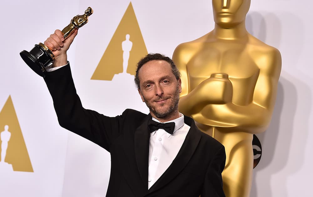 Emmanuel Lubezki poses in the press room with his award for best cinematography for his work on “Birdman