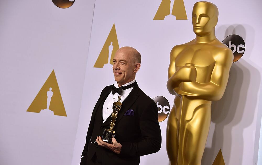 J.K. Simmons poses in the press room with the award for best actor in a supporting role for “Whiplash” at the Oscars.