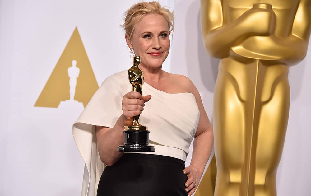 Patricia Arquette poses in the press room with the award for best actress in a supporting role for “Boyhood” at the Oscars.