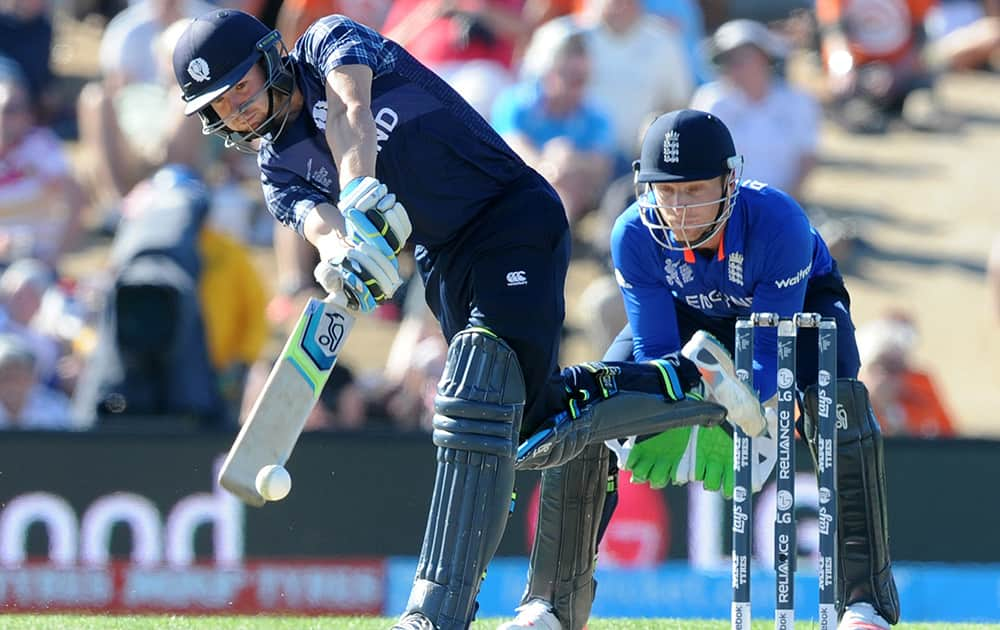 Scotland's Matt Cross hits the ball as England wicketkeeper Jos Buttler watches during their Cricket World Cup match in Christchurch, New Zealand.