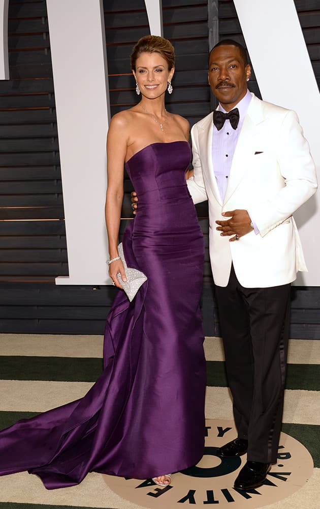 Paige Butcher, left, and Eddie Murphy arrives at the 2015 Vanity Fair Oscar Party.