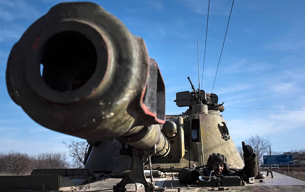 A Ukrainian soldier smiles riding on a self-propelled artillery piece near Artemivsk, eastern Ukraine, Monday.