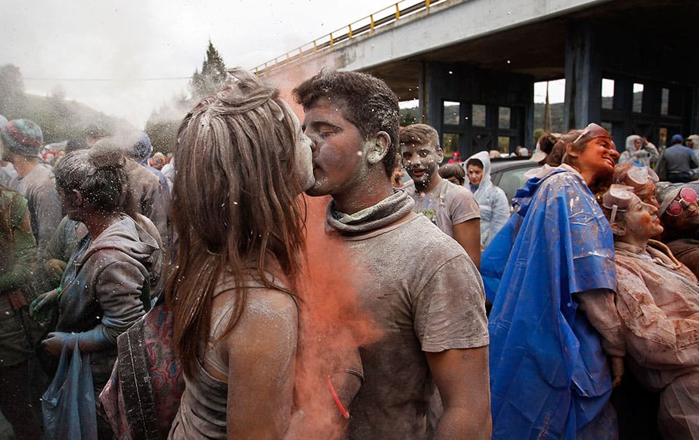 A young couple kiss each other as they celebrate Clean Monday with a flour war, a unique colorful flour fight marking the end of the carnival season in the port town of Galaxidi, some 200 kilometers (120 miles) west of Athens.
