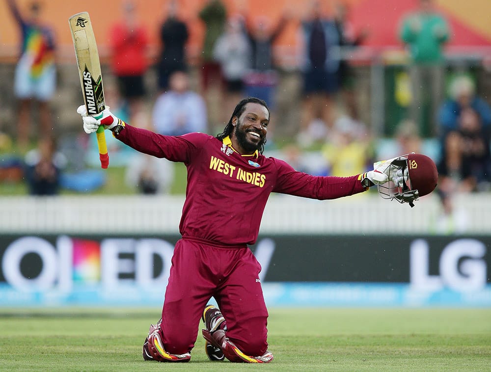 West Indies batsman Chris Gayle celebrates after scoring a double century during their Cricket World Cup Pool B match against Zimbabwe in Canberra, Australia.