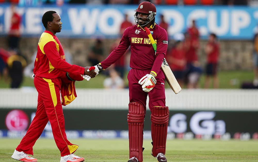 West Indies batsman Chris Gayle is congratulated by Zimbabwe's Tinashe Panyangara after scoring 215 runs during their Cricket World Cup Pool B match in Canberra, Australia.