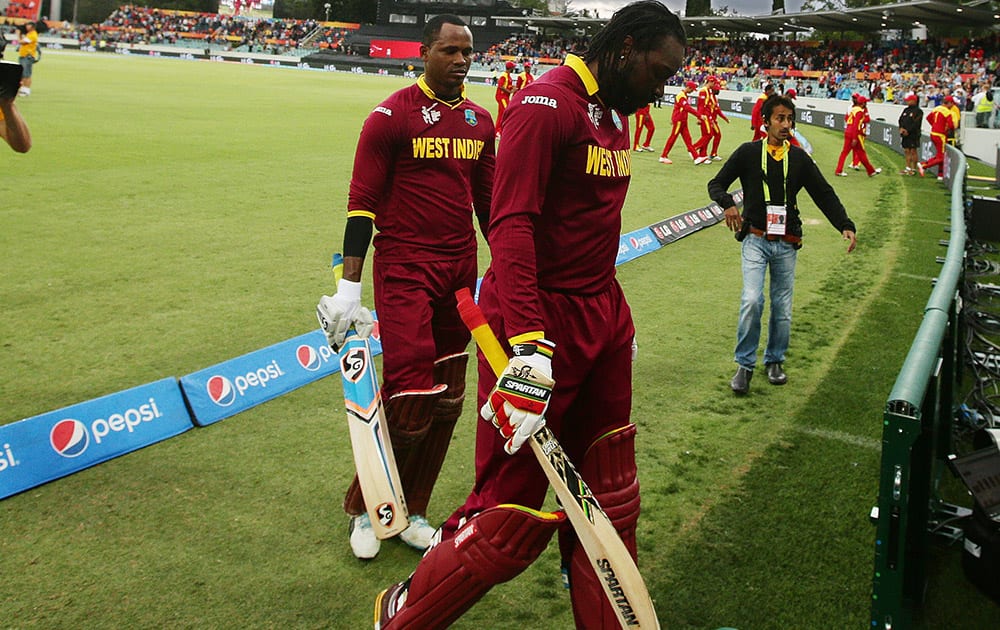 West Indies Chris Gayle and teammate Marlon Samuels leave the field after their record partnership during their Cricket World Cup Pool B match against Zimbabwe in Canberra, Australia.