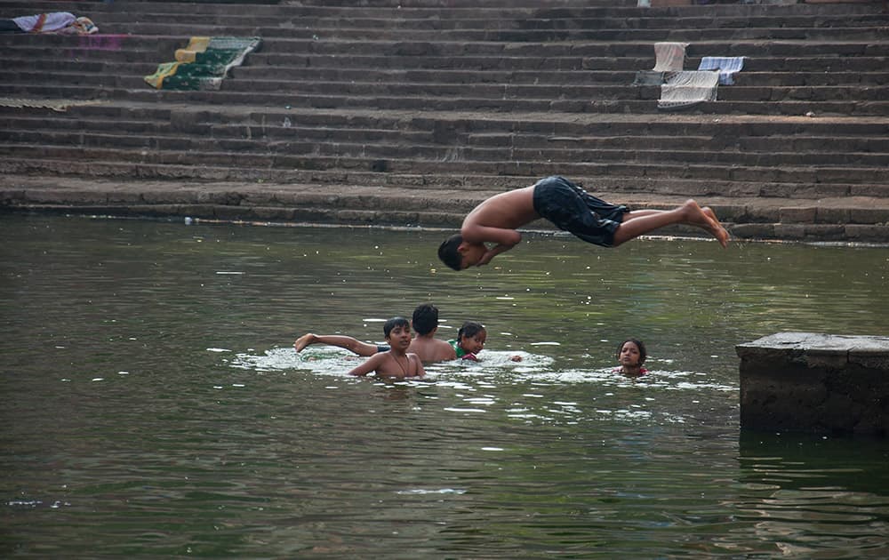 Kids bustling with energy dive in the waters of Walkeshwar's Banganga.