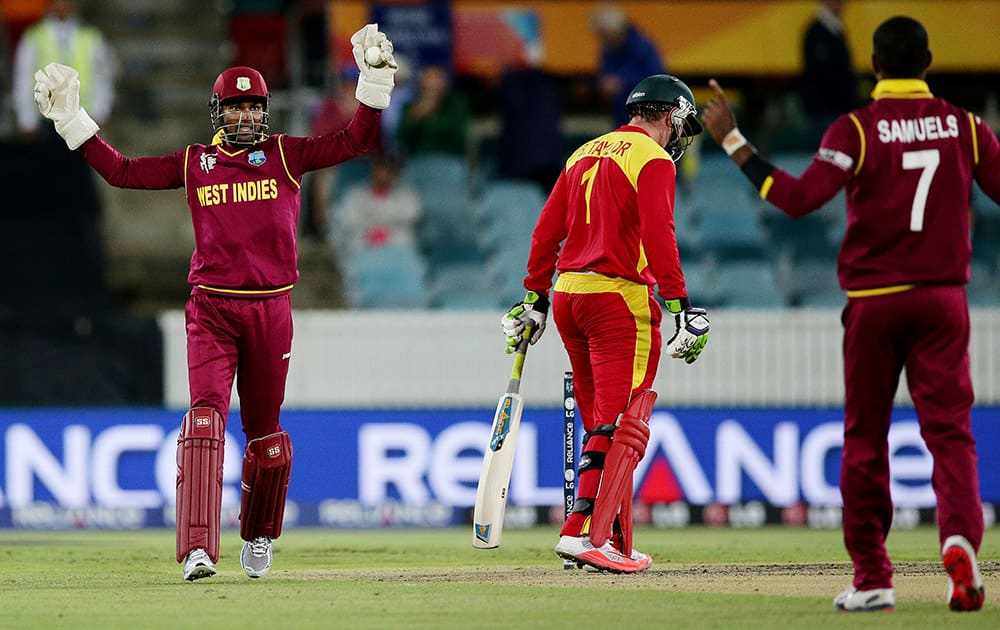 West Indies wicketkeeper Denesh Ramdin appeals successfully for a catch to dismiss Zimbabwe batsman Brendan Taylor for 37 runs off the bowling of teammate Marlon Samuels during their Cricket World Cup Pool B match in Canberra, Australia.