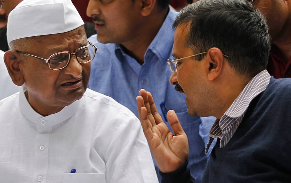 Anna Hazare listens to Delhi chief minister Arvind Kejriwal, who joined him during a protest against the government’s proposed move to ease rules for acquiring land to facilitate infrastructure projects in New Delhi.