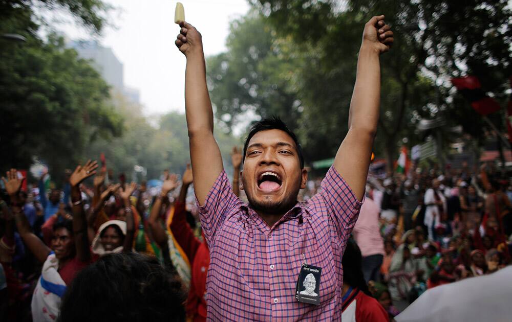 A supporter of India's anti-corruption activist Anna Hazare shouts slogans as he holds an ice stick during a protest against the government’s proposed move to ease rules for acquiring land to facilitate infrastructure projects in New Delhi.