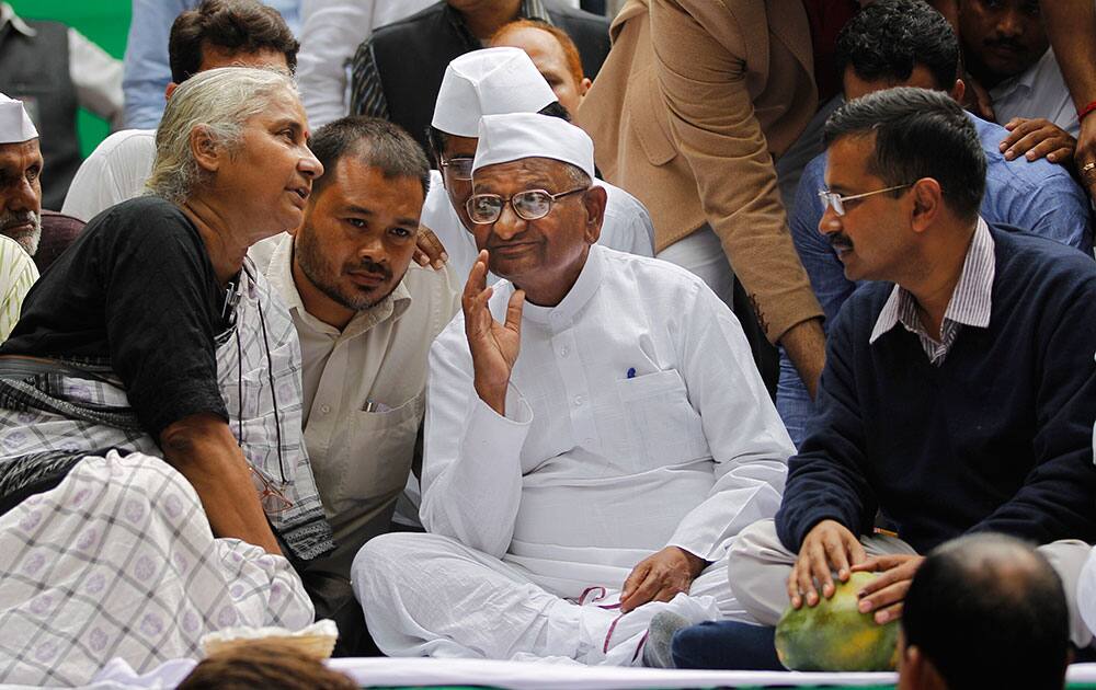 Social activist Medha Patkar speaks to anti-corruption activist Anna Hazare and Delhi chief minister Arvind Kejriwal during a protest against the government’s proposed move to ease rules for acquiring land to facilitate infrastructure projects in New Delhi.