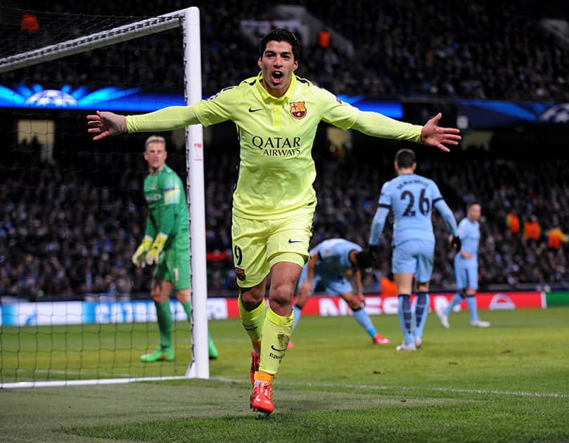 Barcelona's Luis Suarez celebrates after scoring his second goal against Manchester City during the Champions League round 16 match between Manchester City and Barcelona at the Etihad Stadium, in Manchester, England.