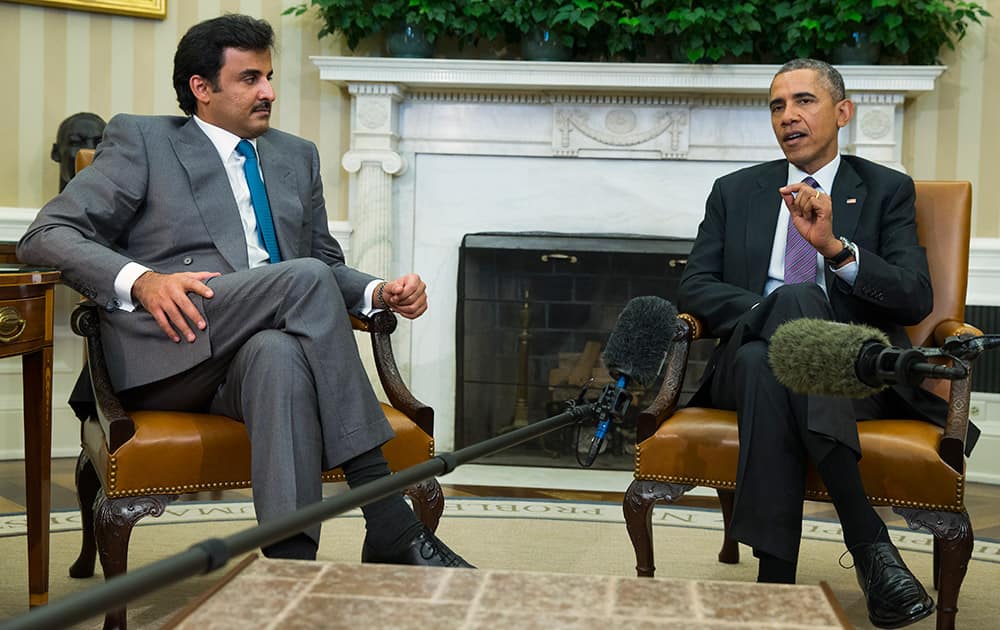 President Barack Obama meets with the Emir of Qatar Sheikh Tamim bin Hamad al Thani, in the Oval Office of the White House in Washington. 