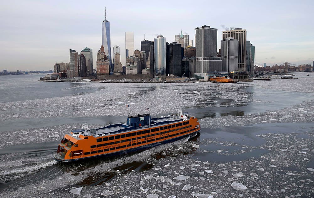 A ferry makes its way through ice in New York. The Weather Service said temperatures would be 15 to 25 degrees below average for most of the East Coast west to the Great Lakes and lower Mississippi River Valley.