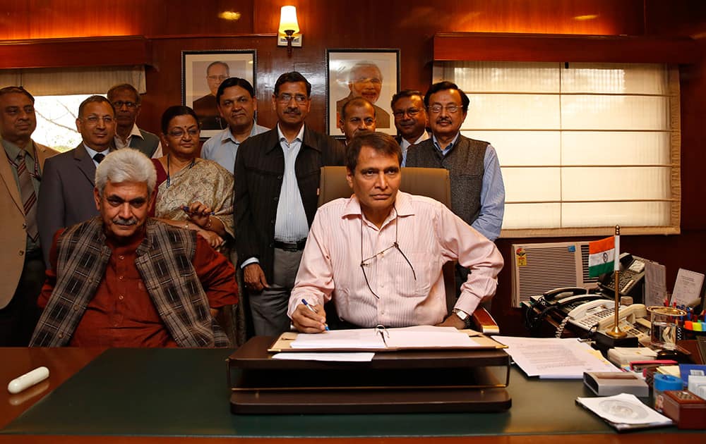 Railway minister Suresh Prabhu poses with his team during a photo call on the eve of the presentation of the Rail budget in Parliament, in New Delhi.