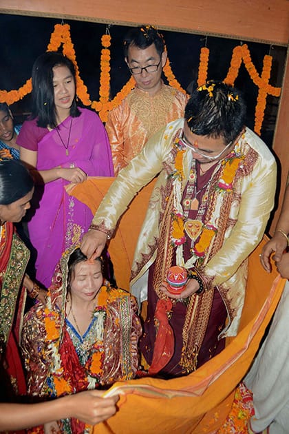 A Chinese couple gets married as per traditional Hindu customs in Bodhgaya.