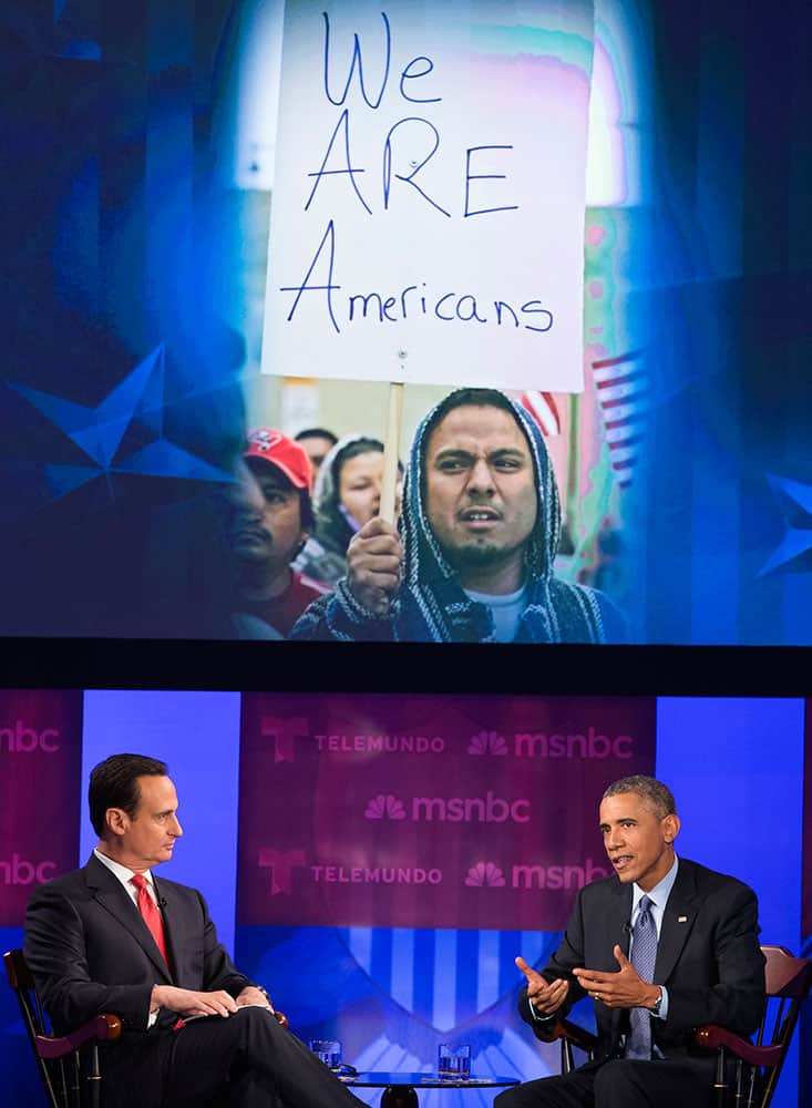 President Barack Obama gestures during a town hall meeting on immigration with MSNBC's Jose Diaz-Balart hosted by Telemundo and MSNBC, at Florida International University in Miami.