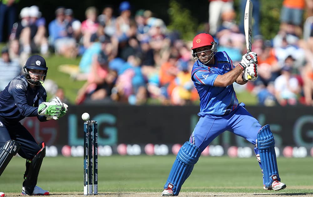 Afghanistans Samiullah Shenwari bats as Scotland wicketkeeper Matt Cross, watches during their Cricket World Cup Pool A match in Dunedin, New Zealand.