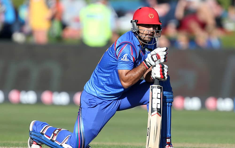 Afghanistan's Samiullah Shenwari rests on his bats during their Cricket World Cup Pool A match against Scotland in Dunedin, New Zealand.