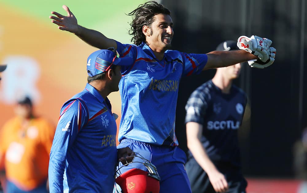 Afghanistan’s Shapoor Zadran celebrates as he leave stye field with a unknown teammate after winning their Cricket World Cup Pool A against Scotland in Dunedin, New Zealand.