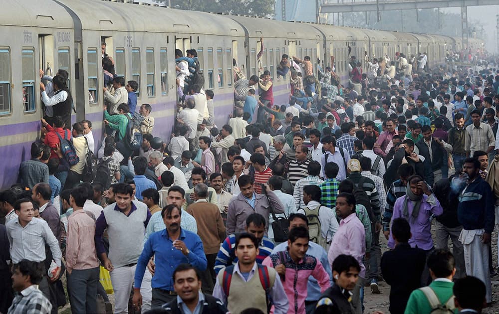 Commuters travel by a train at Loni Railway Station in Ghaziabad. Railway Minister Suresh Prabhu presented the Railway Budget 2015-16 in the Lok Sabha.