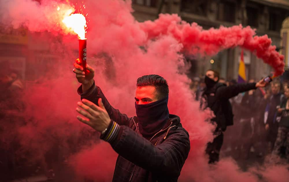 Students march and light flares during the second day of student strike in Madrid, Spain. Students across Spain are protesting changes in the system of university degrees with protests and a two-day strike.