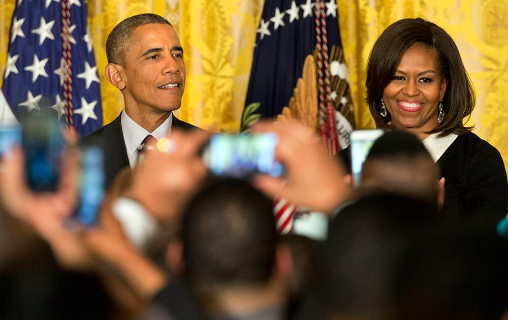 President Barack Obama, speaks next to first lady Michelle Obama during a reception in recognition of African American History Month in the East Room of the White House Washington.