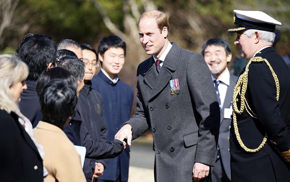 Britain's Prince William, talks people during his visit at Yokohama War Cemetery in Yokohama, near Tokyo. William is on his first visit to Japan. 