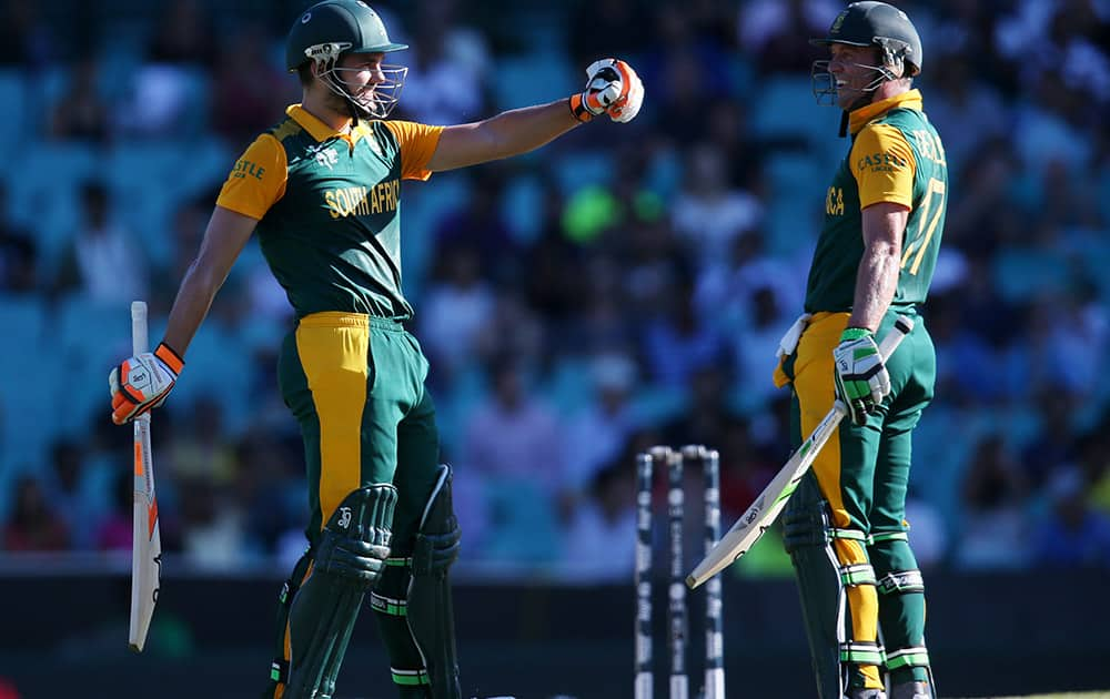 South Africa's Rilee Rossouw celebrates after scoring 50 runs as his captain AB De Villiers watches during their Cricket World Cup Pool B match in Sydney, Australia.